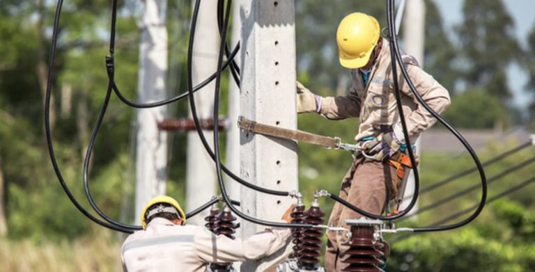 Utility Lineman tied to a telephone pole