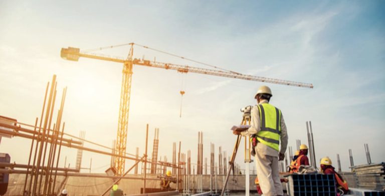 Construction worker surveying construction site
