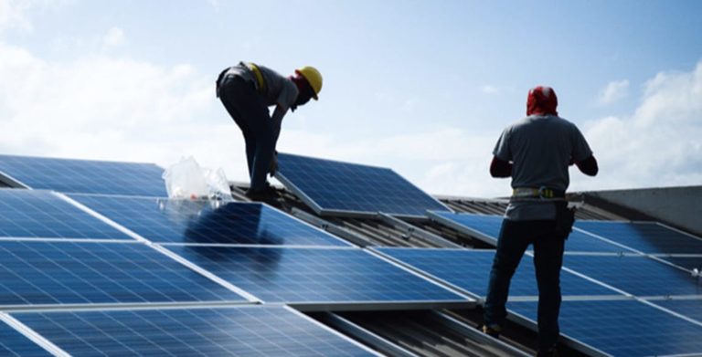 Workers installing solar panels