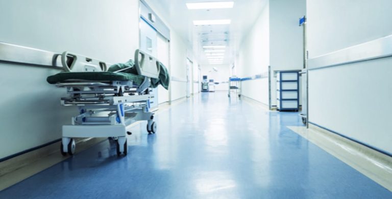 Vacant hospital hallway with a gurney