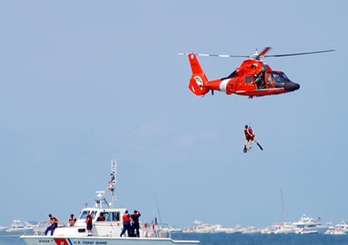 military_use_case Coast Guard being air lifted out of the water