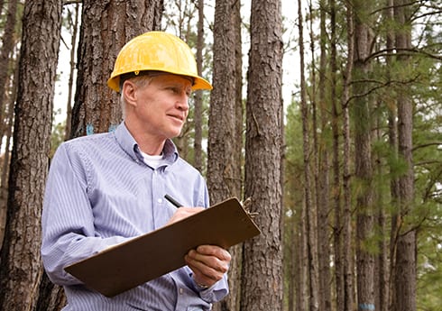 utilities_use_case-header Project Manager checking his clipboard on an outdoor job site