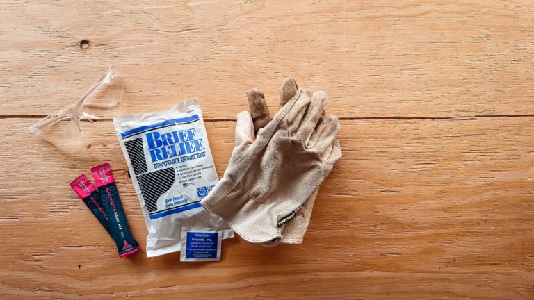 Aerial shot of Brief Relief Pee Bag, gloves, and safety goggles