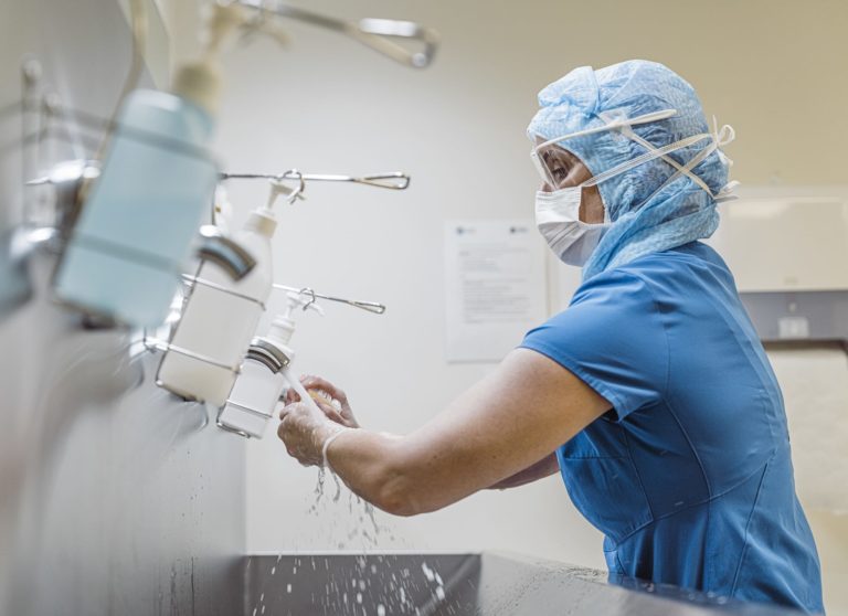 Nurse washing hands to avoid virus.