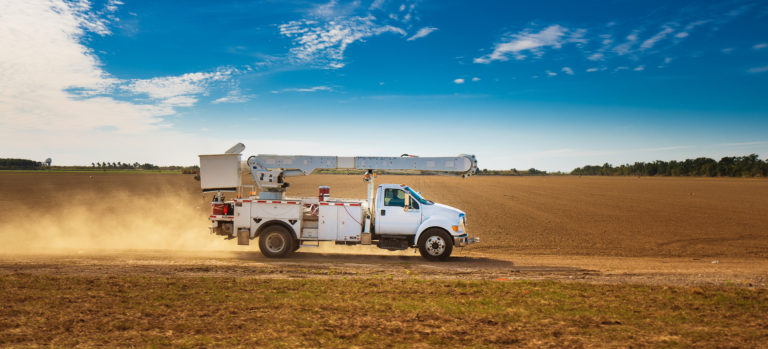 Work Truck Driving on a Remote Dirt Road